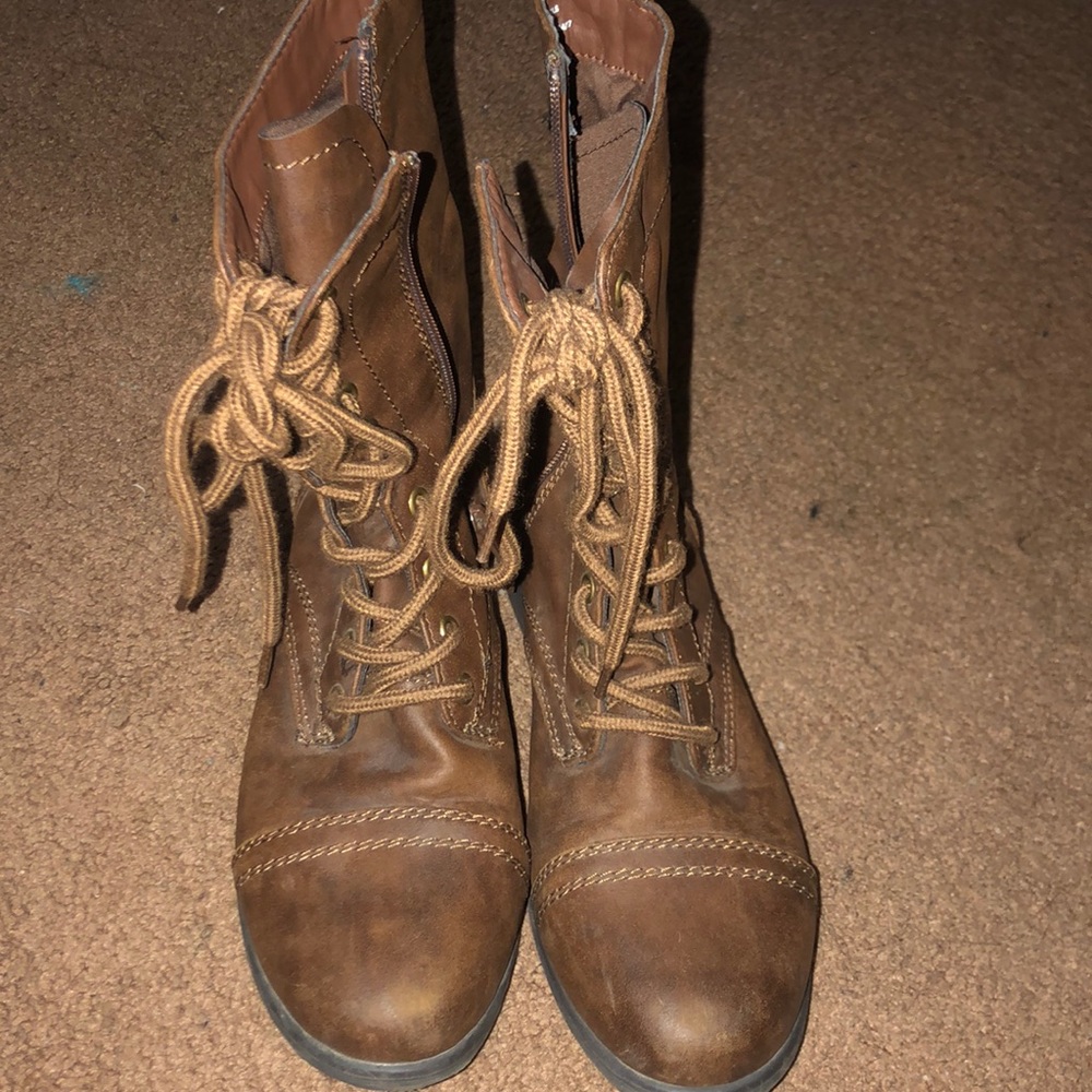Brown combat boots with zippers and laces.